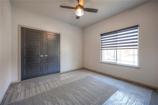 unfurnished room featuring visible vents, baseboards, light carpet, and ceiling fan