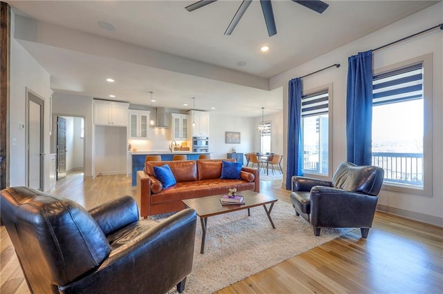 living area with recessed lighting, ceiling fan, baseboards, and light wood-style floors