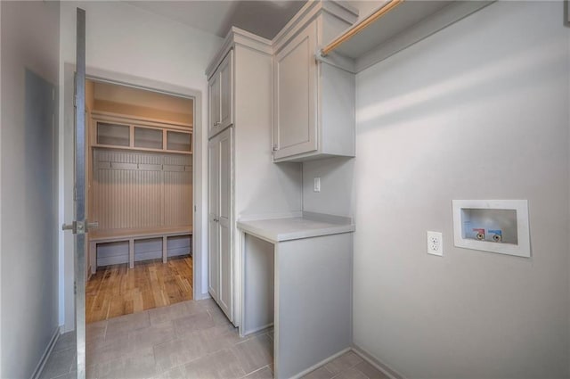 clothes washing area featuring cabinet space and hookup for a washing machine