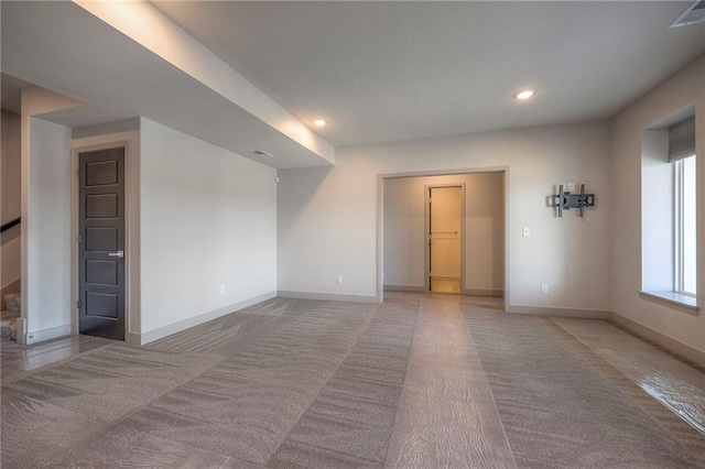 empty room with recessed lighting, baseboards, and light colored carpet