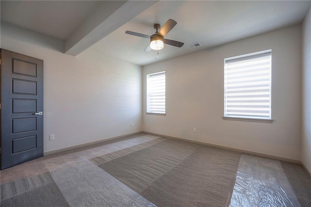 empty room with a ceiling fan, carpet flooring, baseboards, and visible vents