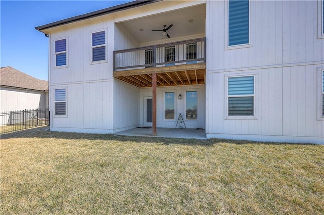 back of property featuring a ceiling fan, a patio, fence, a yard, and a balcony