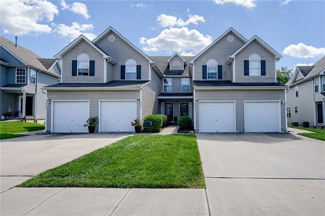 traditional home featuring a residential view, a front lawn, concrete driveway, and a garage