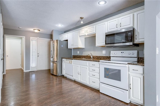 kitchen featuring a sink, dark wood-type flooring, appliances with stainless steel finishes, and white cabinets