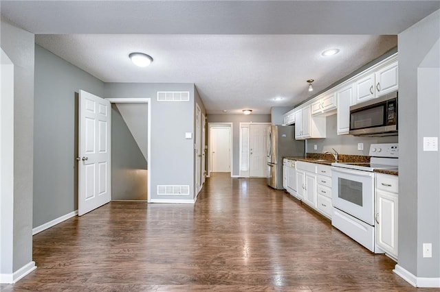 kitchen with dark countertops, visible vents, white cabinets, and appliances with stainless steel finishes