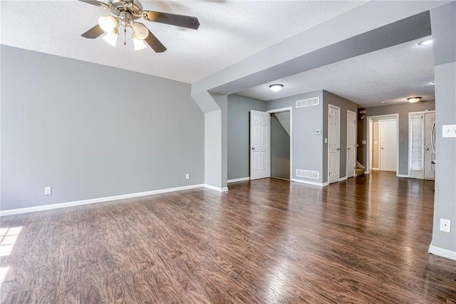 unfurnished living room featuring visible vents, baseboards, wood finished floors, and a ceiling fan