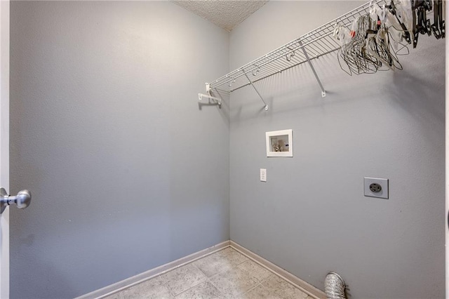 washroom with electric dryer hookup, a textured ceiling, baseboards, hookup for a washing machine, and laundry area