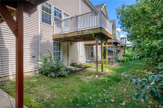 exterior space featuring a yard and a wooden deck