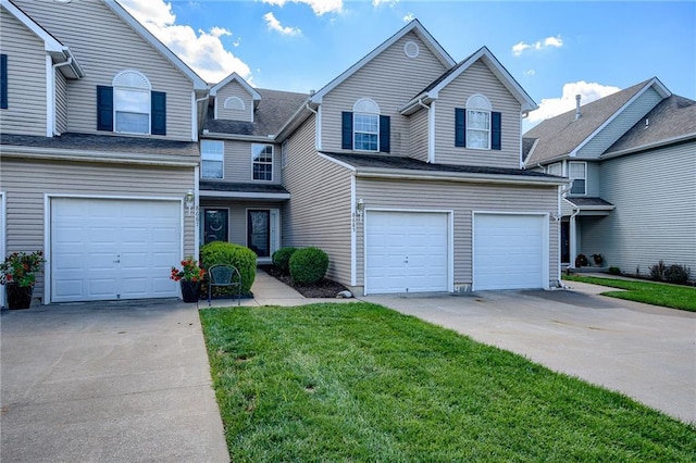 traditional-style home with a garage, a front yard, and driveway