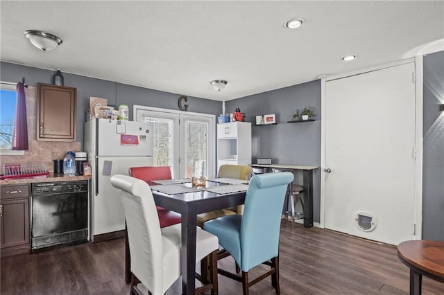 dining space with french doors and dark wood-type flooring