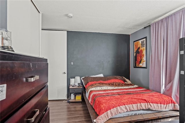 bedroom featuring a textured ceiling and wood finished floors