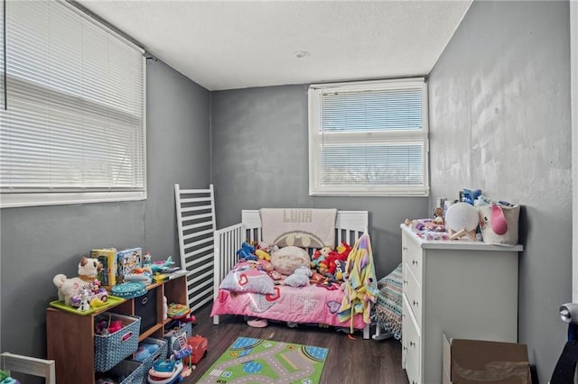 bedroom featuring a textured ceiling and wood finished floors