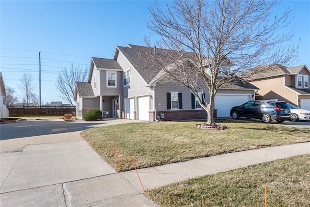 traditional-style home featuring a front yard, fence, roof with shingles, concrete driveway, and brick siding