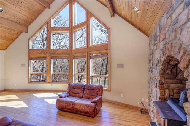 living room with wooden ceiling, beamed ceiling, light wood finished floors, and a wealth of natural light