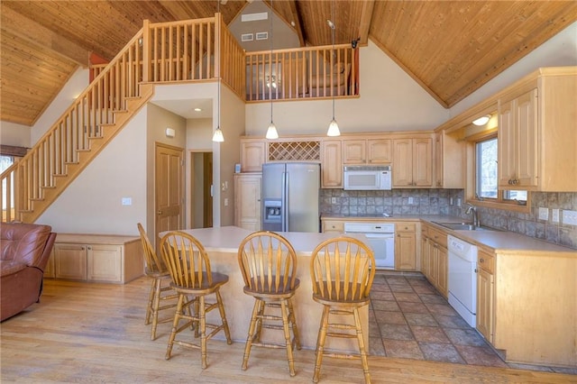 kitchen featuring a sink, white appliances, wood ceiling, and light brown cabinetry