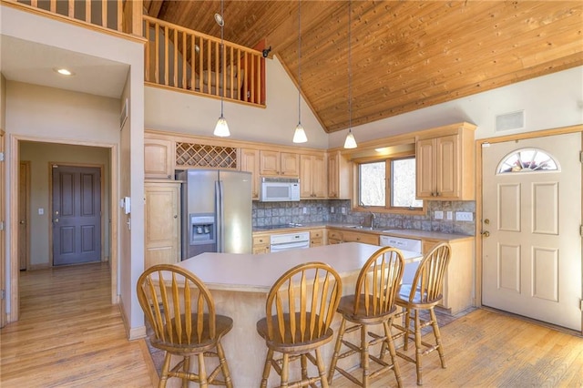 kitchen featuring tasteful backsplash, visible vents, wood ceiling, light wood-type flooring, and white appliances