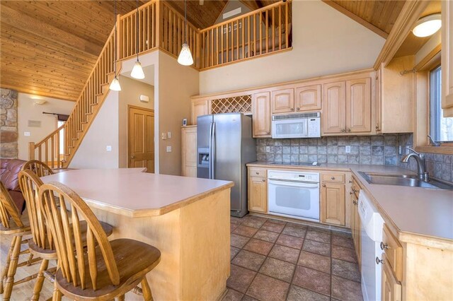 kitchen featuring a sink, white appliances, wooden ceiling, and light brown cabinets