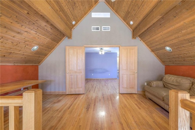 bonus room featuring visible vents, beamed ceiling, and wood finished floors