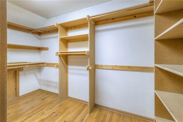 walk in closet featuring wood finished floors