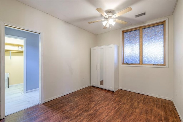 unfurnished bedroom with visible vents, baseboards, and wood finished floors