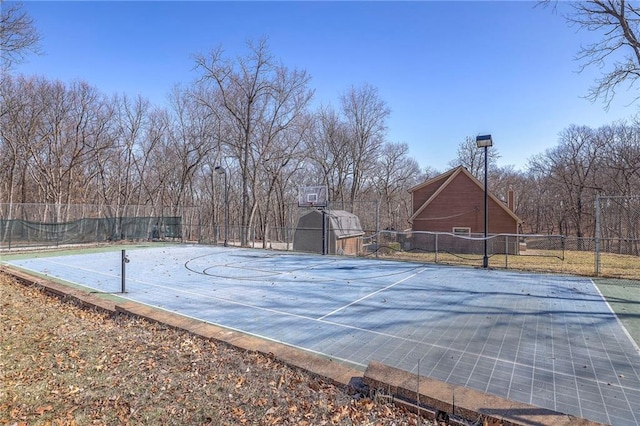 view of basketball court with community basketball court and fence