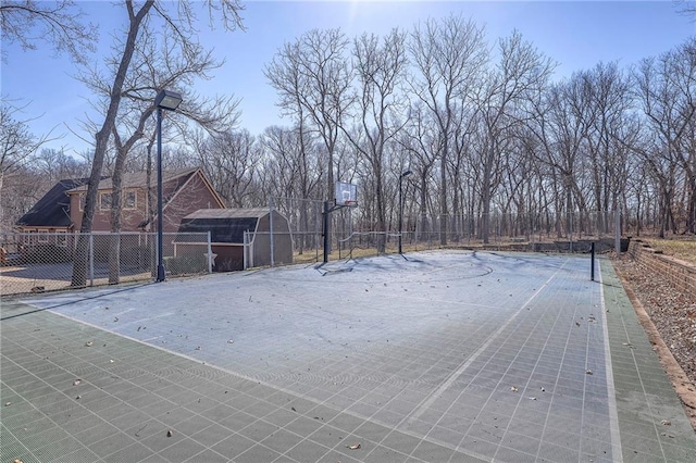 view of yard with community basketball court and fence