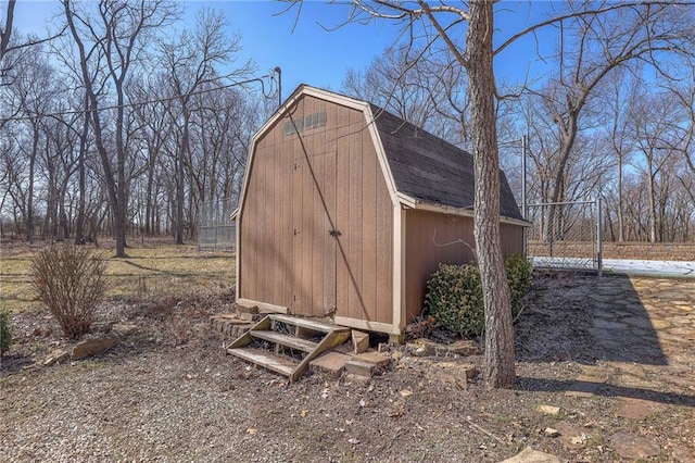 view of shed featuring fence