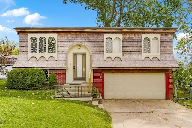 bi-level home with fence, driveway, mansard roof, a front lawn, and brick siding