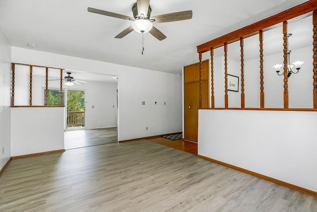 spare room featuring a ceiling fan, wood finished floors, and baseboards