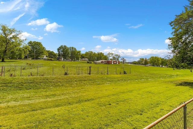 view of yard featuring a rural view and fence