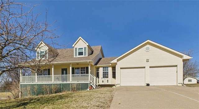 cape cod home with concrete driveway, an attached garage, covered porch, and a front yard