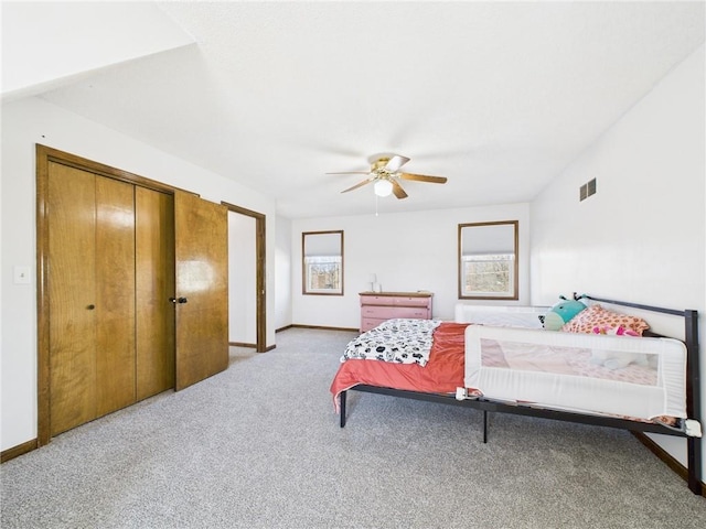 bedroom featuring light carpet, visible vents, a ceiling fan, and baseboards