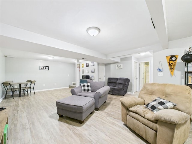 living room with light wood finished floors, beam ceiling, and baseboards