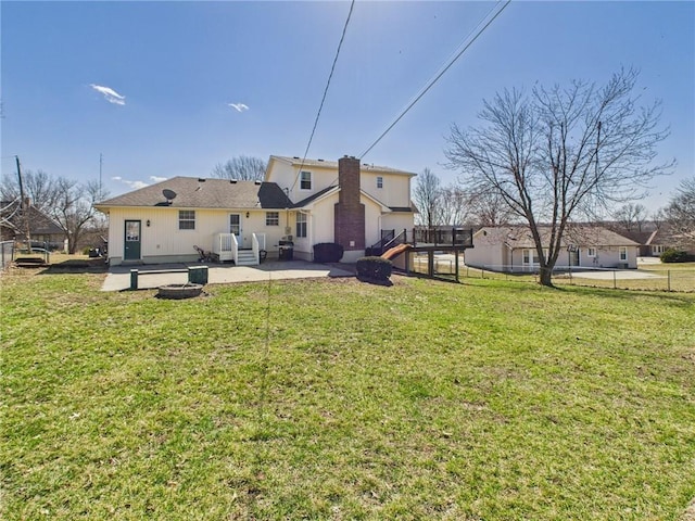 back of property featuring a patio area and a lawn