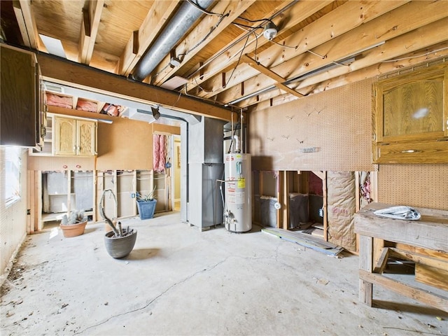 misc room featuring gas water heater, a workshop area, and unfinished concrete flooring