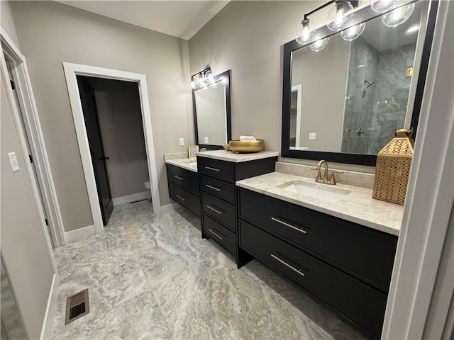 full bathroom featuring visible vents, toilet, a stall shower, baseboards, and vanity