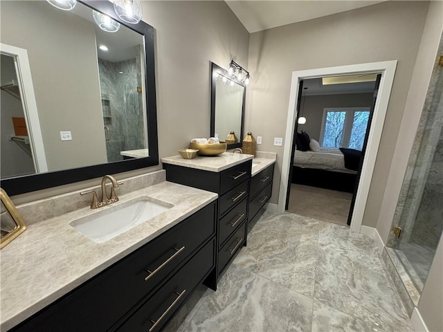 ensuite bathroom featuring a shower stall, baseboards, ensuite bathroom, marble finish floor, and vanity