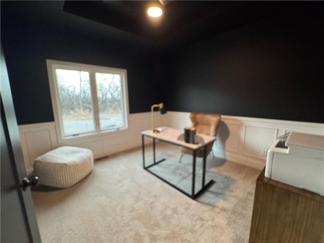 home office featuring light colored carpet and wainscoting