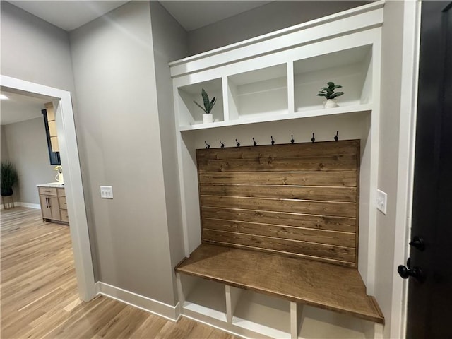 mudroom featuring light wood-style flooring and baseboards