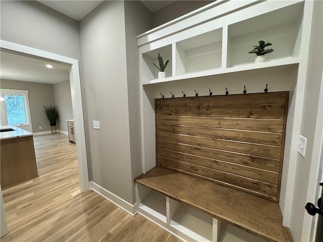 mudroom featuring light wood-style flooring and baseboards