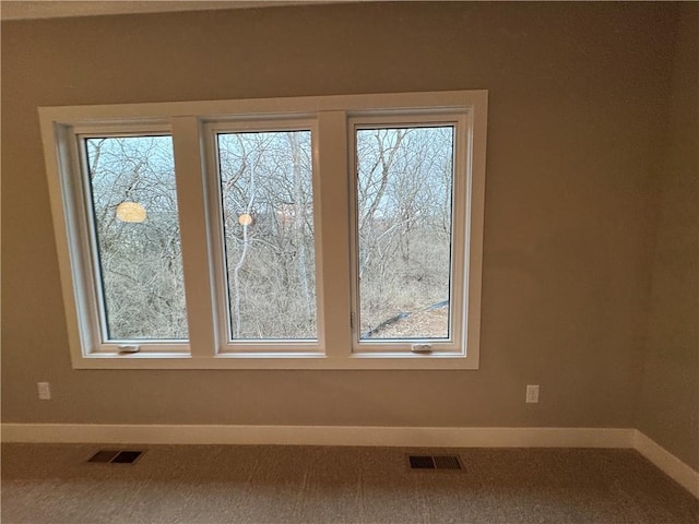 room details with visible vents, carpet flooring, and baseboards