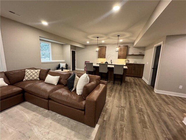 living room featuring recessed lighting, visible vents, baseboards, and dark wood finished floors