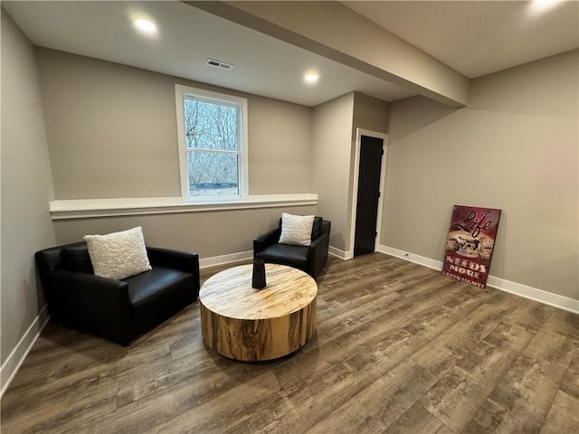 living area with recessed lighting, visible vents, baseboards, and wood finished floors