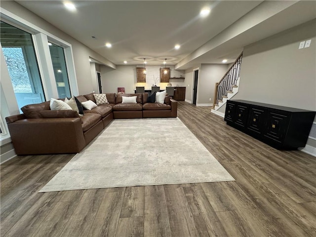 living area featuring stairway, recessed lighting, dark wood-type flooring, and baseboards