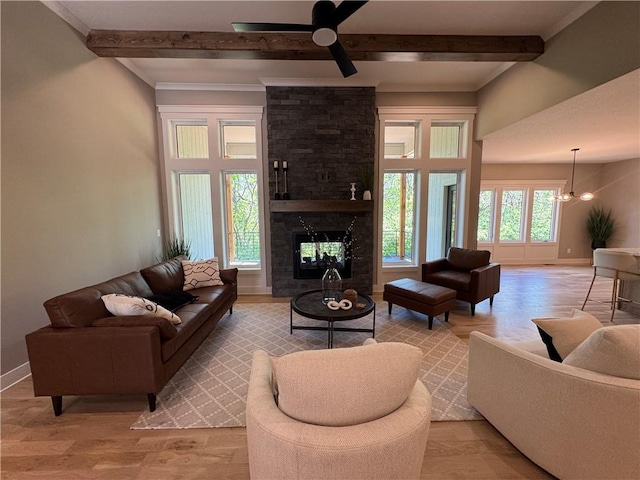 living area with baseboards, light wood finished floors, ceiling fan, and beam ceiling