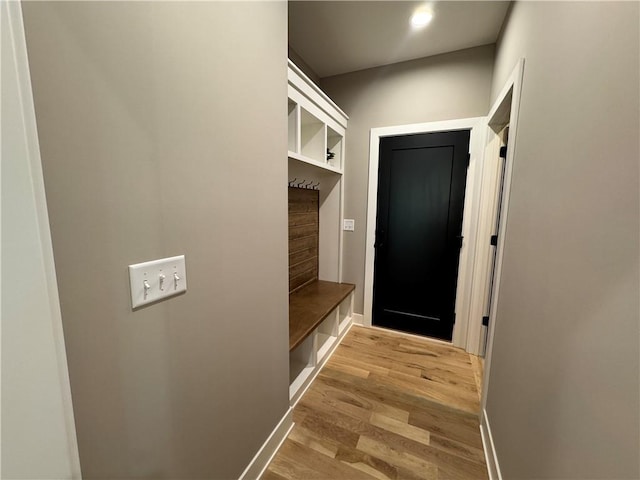mudroom with recessed lighting, baseboards, and wood finished floors