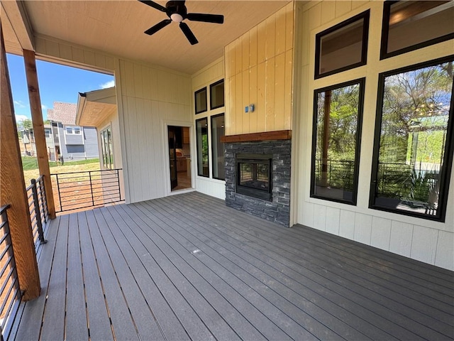 wooden terrace featuring a ceiling fan