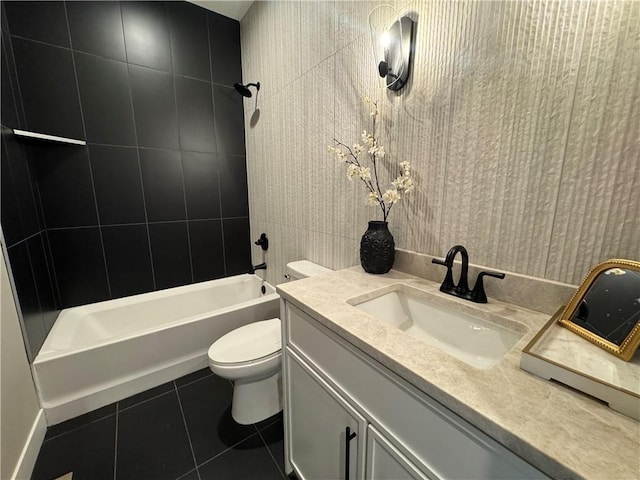 bathroom featuring toilet, tile patterned floors, tub / shower combination, and vanity