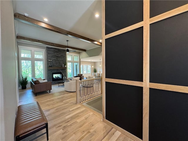 corridor featuring recessed lighting, beam ceiling, an upstairs landing, and wood finished floors
