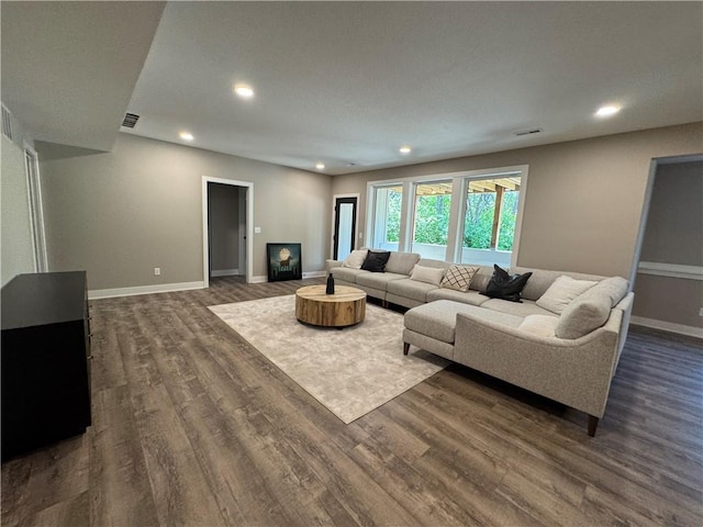 living area with recessed lighting, baseboards, dark wood finished floors, and visible vents